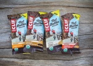 Four CLIF Nut Butter Filled bars on wood