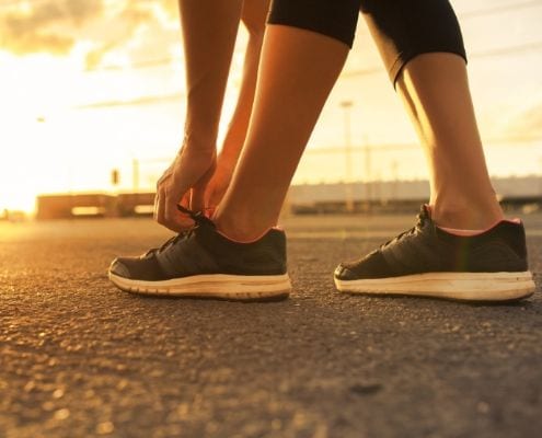 Runner ties shoes before going on a morning run.