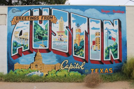 Image of the Greetings from Austin mural. Snap a picture when you visit 2 of the south Austin coffee shops on our list!