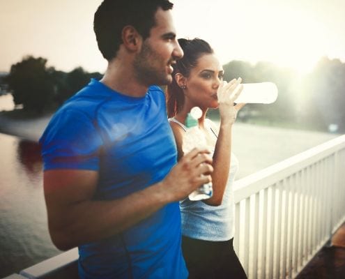 Runners hydrating during a run. Nuun is the Official Hydration of the 2020 Ascension Seton Austin Marathon.