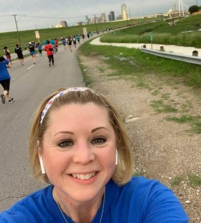 Image of Christy Thomas at a running event. She began running because she wanted to make a lifestyle change. Christy will run the 2020 Austin Half Marathon!