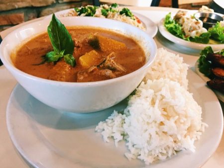 Image of a bowl of pumpkin curry and a plate of white rice from Thai, How Are You?. Thai, How Are You? is one of 5 Austin restaurants along the Austin Marathon course that people should visit.