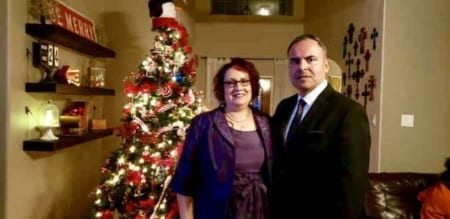 Image of Rene Arguello and Veronica, his wife, next to a Christmas tree. He's dedicating his first marathon to her!