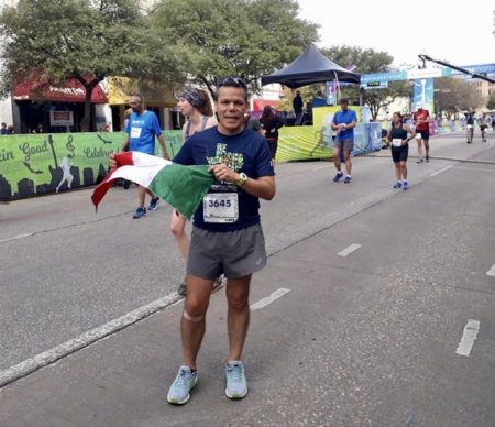 Jose Antonio Santiago poses at the 2019 Austin Marathon finish line with a Mexican flag. His life-changing journey began when he started running nine years ago.