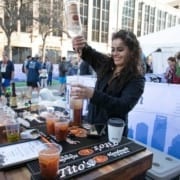 Image of a bartender pouring a drink with Tito's Handmade Vodka at the 2019 Austin Marathon Hilton VIP Experience.