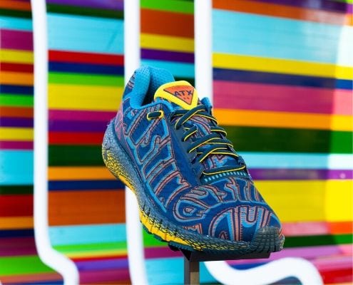 Image of the limited-edition Under Armour HOVR Machina ATX shoe in front of a multi-colored ATX sign. The Austin Marathon is giving away a pair of these shoes every day in April for their 30th Anniversary Giveaway! Credit: Fleet Feet Austin.