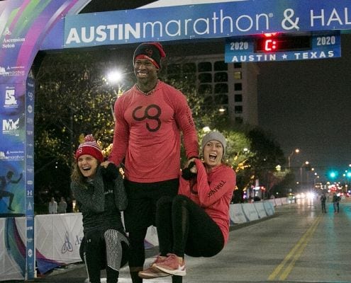 Image of Camp Gladiator Trainers warming up participants before the 2020 Austin Marathon. You can workout with their Trainers from anywhere in the world when you register for their Choose to Move virtual challenge today!