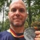 Image of Jonathan Acott showing off his medal from the Berlin Marathon. Read about his journey to run the world and how the Austin Marathon is next!