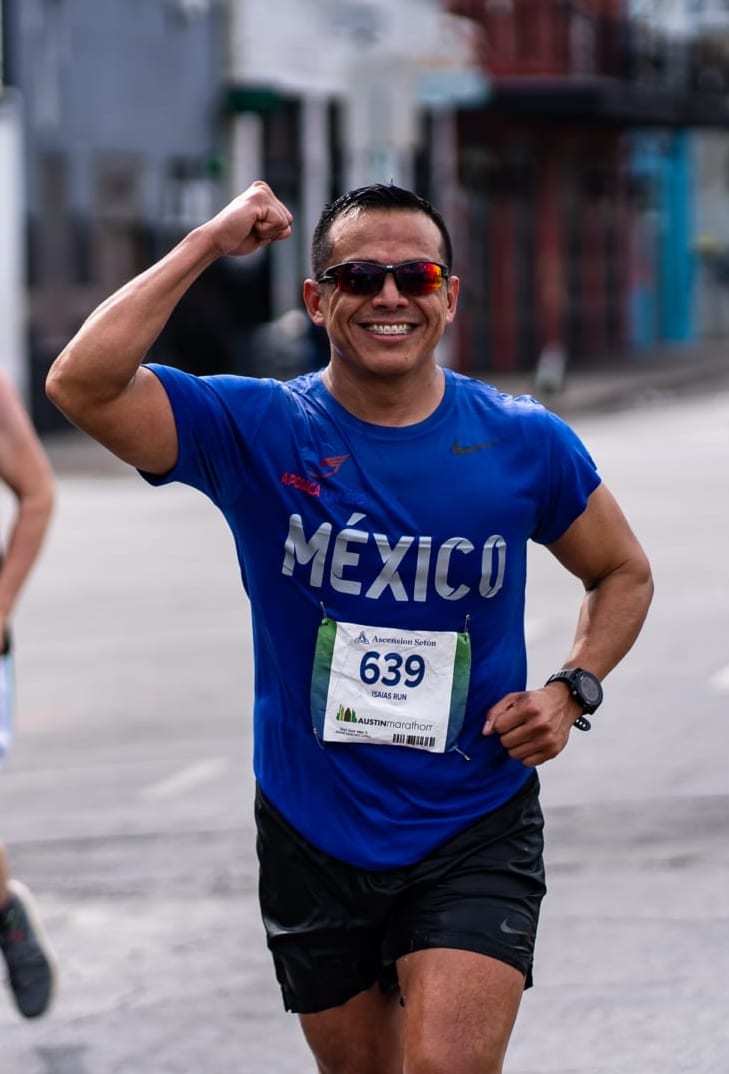 Image of runner from Mexico with his right arm flexed during the 2020 Ascension Seton Austin Marathon. This blog post have tips for first-time runners, like how to be relaxed and run your best.