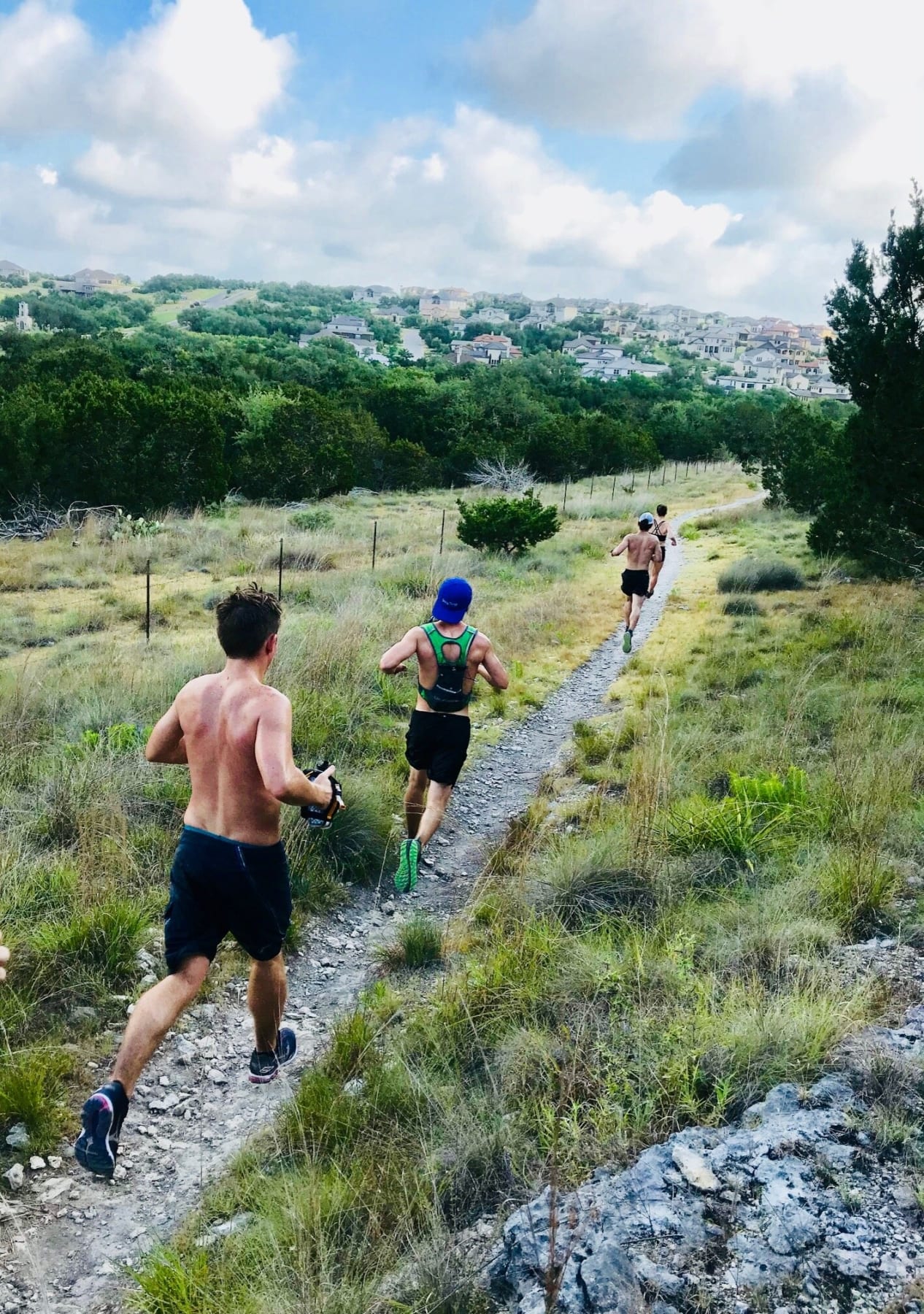 Image of runners running one of Austin's top running trails. Credit to Trail Roots.