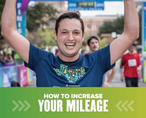 Image of male runner with his hands raised in the air in celebration after crossing the 2019 Ascension Seton Austin Marathon. Design on the image contains text that reads How to Increase Your Mileage.