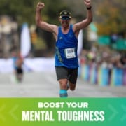 Runner crosses the Austin Marathon finish line with both arms raised triumphantly. Text on design reads Build Your Mental Toughness. Learn more at https://youraustinmarathon.com/build-mental-toughness/