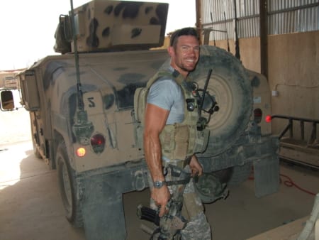 Nate Boyer smiles for the camera in front of a Humvee while serving as a Green Beret. Image courtesy of Nate Boyer.