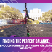 A runner in athletic gear is mid-stride during a race, with a cityscape and trees in the background. Confetti is scattered on the ground. Text below the image reads, "Finding the Perfect Balance: Should Runners Lift Heavy or Light Weights? Austin Marathon Half Marathon & 5K