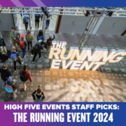 A group of people stroll past an illuminated "The Running Event 2024" sign at a bustling conference. The image, titled "High Five Events Staff Picks: Top Gear at The Running Event 2024," is framed with a striking purple and blue gradient border. Austin Marathon Half Marathon & 5K