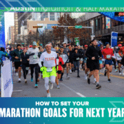 Runners in athletic gear participate in a city marathon. Spectators line the street, and banners hang overhead. Text at the bottom reads, "How to set your marathon goals for next year. Austin Marathon Half Marathon & 5K