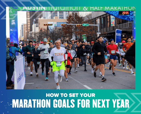 Runners in athletic gear participate in a city marathon. Spectators line the street, and banners hang overhead. Text at the bottom reads, "How to set your marathon goals for next year. Austin Marathon Half Marathon & 5K