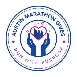Circular logo with “Austin Marathon Gives” at the top and “Run With Purpose” at the bottom. In the center, two hands hold a heart featuring the Austin skyline, highlighting Austin Marathon Charities with confetti and heart accents. Austin Marathon Half Marathon & 5K