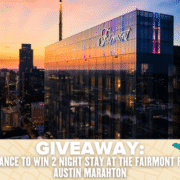 A modern glass hotel building with "Fairmont" sign at sunset, overlooking the Austin skyline. Text reads: "GIVEAWAY: Enter for a chance to win a 2-night stay at the Fairmont during the Austin Marathon. Austin Marathon Half Marathon & 5K
