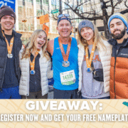Five smiling people wearing medals pose together outdoors at a race event. The text below reads: "GIVEAWAY: Register now and get your Free NamePlate." Music notes and star icons decorate the banner. Austin Marathon Half Marathon & 5K