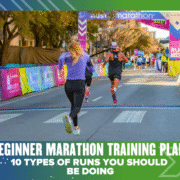 A woman and a man run toward the finish line of a marathon on a city street, surrounded by colorful banners. Text on the image reads: "Beginner Marathon Training Plan: 10 Types of Runs You Should Be Doing." Perfect for new runners!. Austin Marathon Half Marathon & 5K