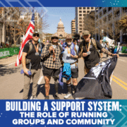 Four smiling runners pose with medals, flags, and gear on a city street near the Texas State Capitol during a race event—highlighting the power of running groups and community in building a strong support system. Austin Marathon Half Marathon & 5K