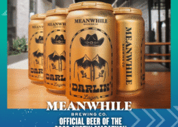 Four gold cans of Meanwhile Brewing Co.'s Darlin' Lager are arranged on a table. Text below announces Meanwhile Brewing Co. as the Official Beer of the 2026 Austin Marathon. Austin Marathon Half Marathon & 5K