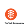 An orange circle with a white tree-like symbol and the letters "T" and "C" combined. Below the circle, bold black text reads "The Trail Conservancy," supporting marathon fundraising and race for a cause initiatives. Austin Marathon Half Marathon & 5K