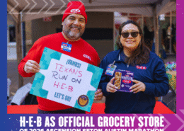 Two H-E-B employees smile at an event. The man holds a “¡VAMOS! Texans run on H-E-B” sign, while the woman displays protein bars. A banner announces H-E-B as the official grocery store of the Ascension Seton Austin Marathon. Austin Marathon Half Marathon & 5K