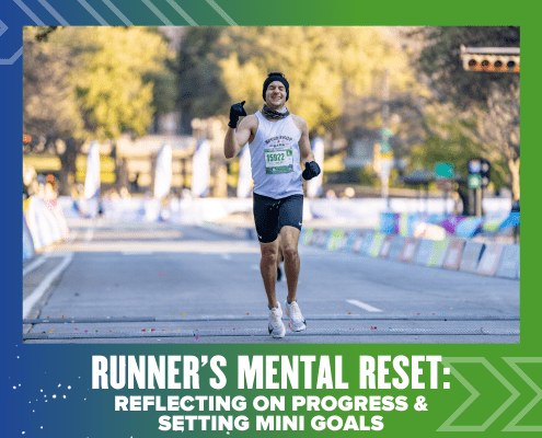 A smiling runner in a race, wearing a white tank top and black gloves, lifts his arms in celebration as he nears the finish line—capturing the power of a runner’s mental reset by reflecting on progress and setting mini goals. Austin Marathon Half Marathon & 5K