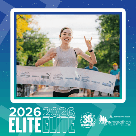 A smiling runner crosses the finish line with one arm raised, making a gesture. The race banner and sponsor logos are visible, along with trees and people in the background. Text below reads 