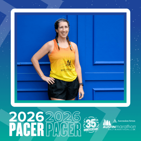 A smiling woman in a yellow and orange 