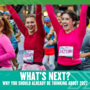 Two women in pink tops, smiling and raising their arms as they run a race, surrounded by other runners. Text below reads, "WHAT'S NEXT? Why strategic planning for 2027 should already be on your radar. Austin Marathon Half Marathon & 5K