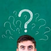 A person looks up with only the upper part of their face visible, against a green background with several chalk-drawn question marks above their head, suggesting confusion or curiosity during mental recovery. Austin Marathon Half Marathon & 5K