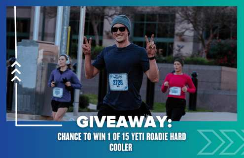 A smiling runner in sunglasses and a beanie flashes peace signs during a race. Other runners are visible behind. Text reads: "Giveaway: Chance to win 1 of 15 Yeti Roadie Hard Cooler." Perfect template for your next promo!. Austin Marathon Half Marathon & 5K