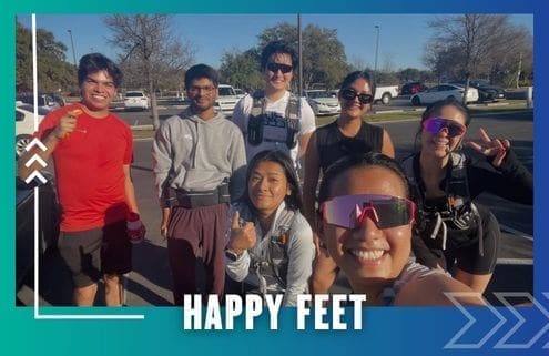 A group of seven smiling people pose outdoors in athletic wear under sunny skies, representing the Buda Running Club. Text at the bottom reads "HAPPY FEET." The image is framed with a blue and teal border and graphics. Austin Marathon Half Marathon & 5K