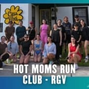 A group of women and a few men in athletic wear pose and smile outside a building with a yellow "Casa Vibra" sign, representing their running club. Text at the bottom reads "HOT MOMS RUN CLUB - RGV. Austin Marathon Half Marathon & 5K