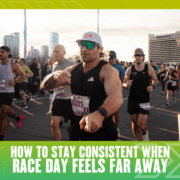 A group of runners participates in a race on a city street, with sunlight and tall buildings in the background. Text at the bottom reads, "How to stay consistent with training when race day feels far away. Austin Marathon Half Marathon & 5K