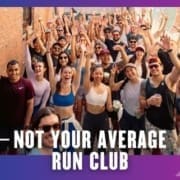 A large, diverse group of smiling people in athletic wear poses cheerfully for a photo in an alley, some raising their hands. Text reads: “Not Your Average Run Club.” Celebrate every Group Run with the Buda Running Club!. Austin Marathon Half Marathon & 5K