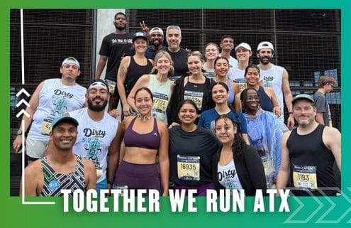 A diverse group of runners from the Buda Running Club pose together and smile for a photo after a race. Most wear race bibs and athletic gear. Text below reads, "TOGETHER WE RUN ATX," with a green gradient border in the background. Austin Marathon Half Marathon & 5K